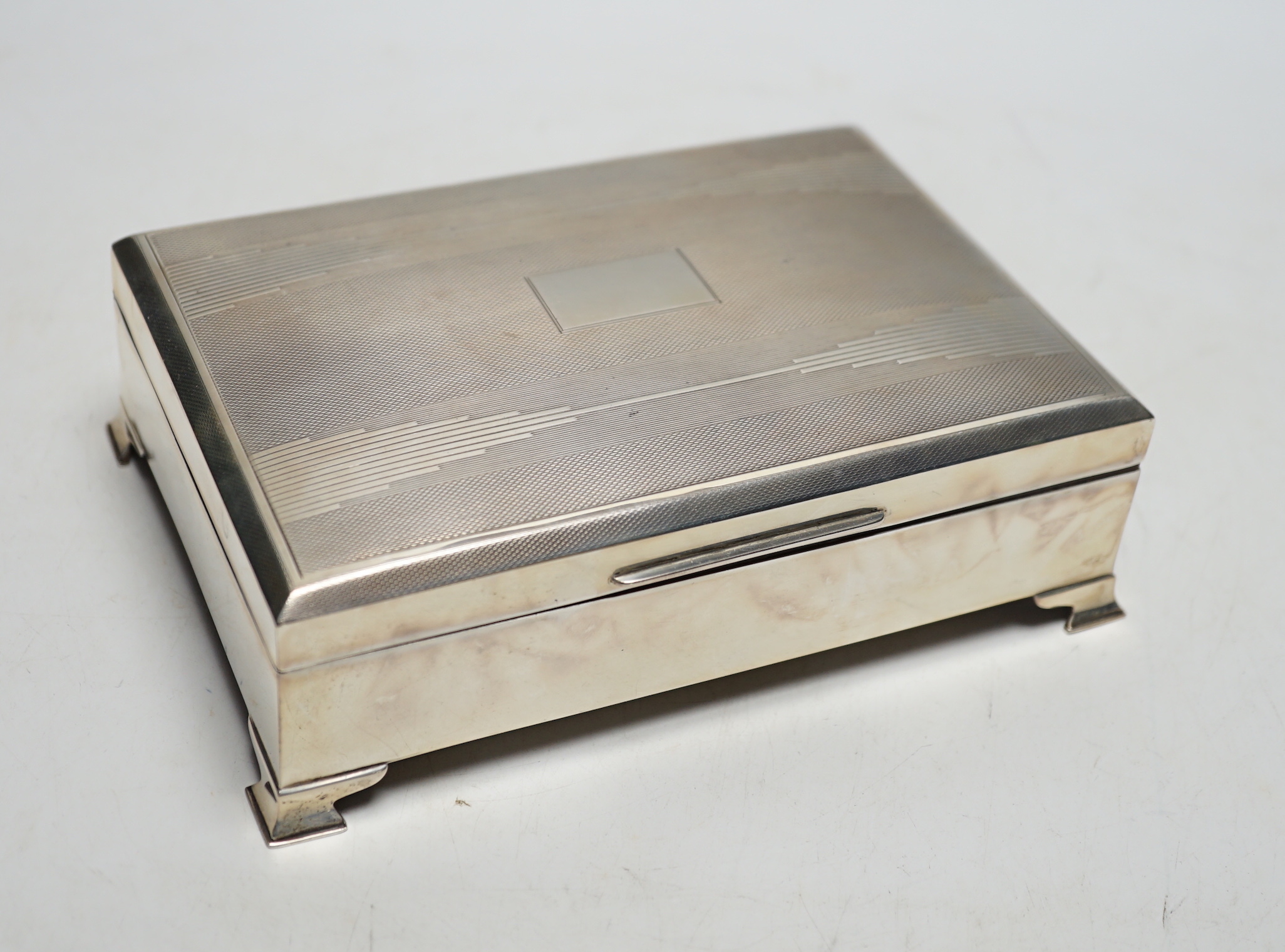 An Art Deco part engine turned silver rectangular cigarette box, Birmingham, 1937, 16.9cm.